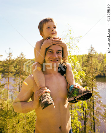 young pretty man model with little cute son playing together, li 41569680