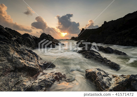 waves splashing on the unique rocks formation 41571472