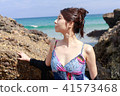 Woman posing on the beach in summer 41573468