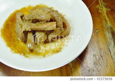 roasted pork slice in white plate on wooden table roasted pork slice in white plate on wooden table 41573636