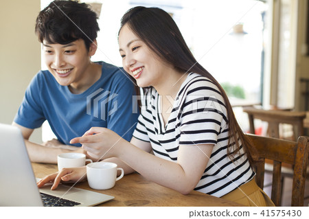 Casual young men and women using personal computers 41575430