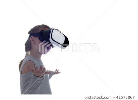 Girl using a virtual reality headset Girl using a virtual reality headset 41575867