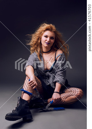 Red-haired pretty woman with nippers Red-haired pretty woman with nippers 41576703