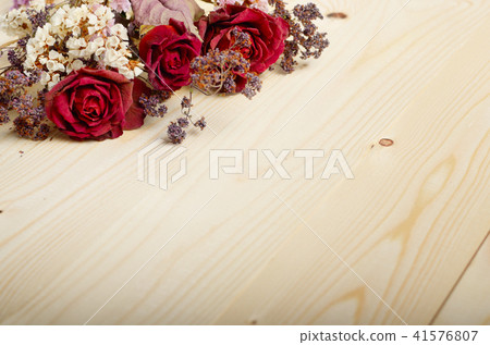 Bouquet of dry flowers and roses on wooden table Bouquet of dry flowers and roses on wooden table 41576807