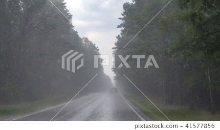 Road during heavy rain. Car on asphalt Road during heavy rain. Car on asphalt 41577856
