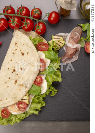 Piadina romagnola with cheese and ham Piadina romagnola with cheese and ham 41577888