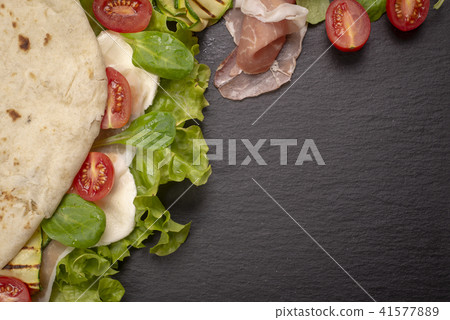Piadina romagnola with cheese and ham 41577889
