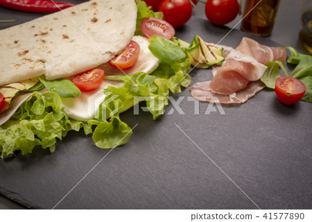 Piadina romagnola with cheese and ham 41577890