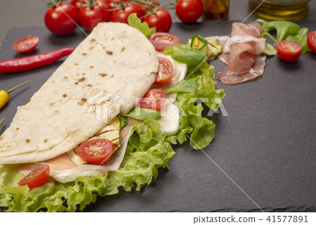 Piadina romagnola with cheese and ham 41577891