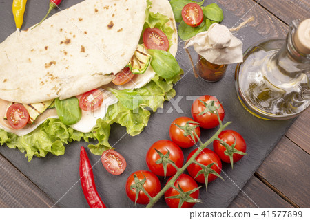Piadina romagnola with cheese and ham 41577899
