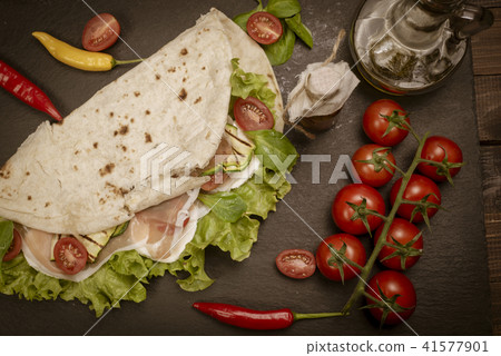 Piadina romagnola with cheese and ham Piadina romagnola with cheese and ham 41577901