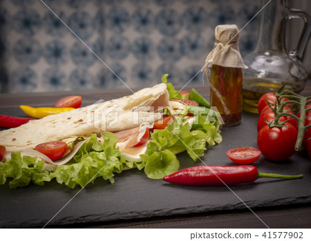 Piadina romagnola with cheese and ham 41577902