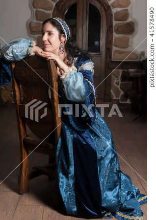 Attractive smiling woman in blue baroque dress 41578490