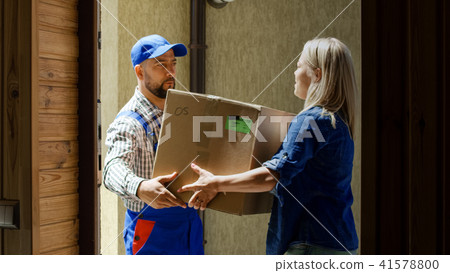 Woman receiving mail box with courier Woman receiving mail box with courier 41578800
