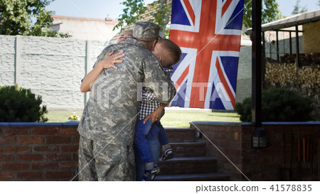 Loving family meeting soldier back at home Loving family meeting soldier back at home 41578835