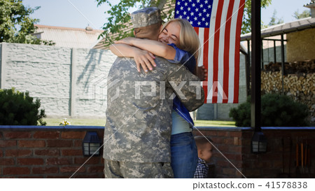 Loving family meeting soldier back at home Loving family meeting soldier back at home 41578838