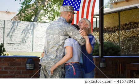 Excited family meeting serviceman at home Excited family meeting serviceman at home 41578841
