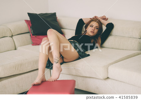 Young woman wearing a short skirt showing her panties 41585839