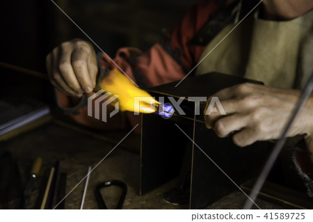 Blowing glass in a traditional way 41589725