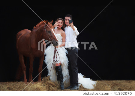 Young couple, groom and bride selfie with horse Young couple, groom and bride selfie with horse 41592070
