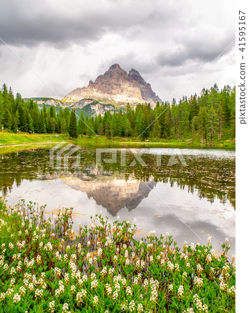 Tre Cime di Lavaredo, aka Drei Zinnen, reflection in water of Antorno Lake with dramatic stormy sky 41595167