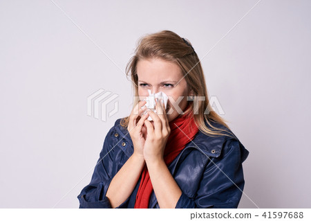 Young girl with cold. Bad feel. Light background Young girl with cold. Bad feel. Light background 41597688