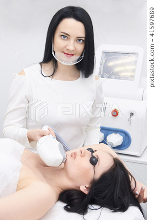 Young girl. Laser hair removal. Cosmetic procedure Young girl. Laser hair removal. Cosmetic procedure 41597689