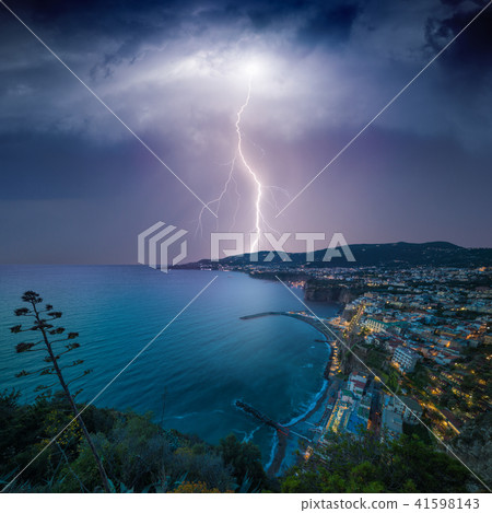 Lightning from stormy sky strikes coastal city 41598143