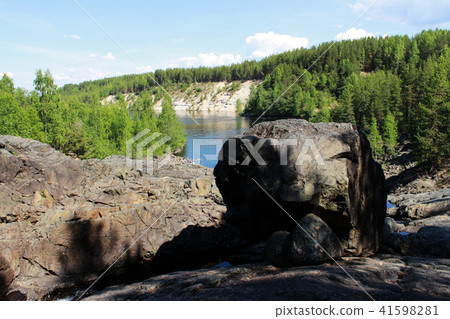 black large stone in the form of a dog's head in place of an extinct volcano Girvas. Karelia, Russia 41598281