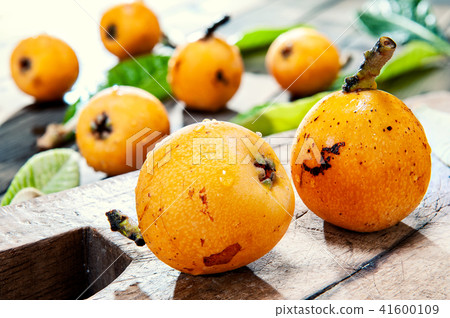 Fresh loquats on wooden background 41600109