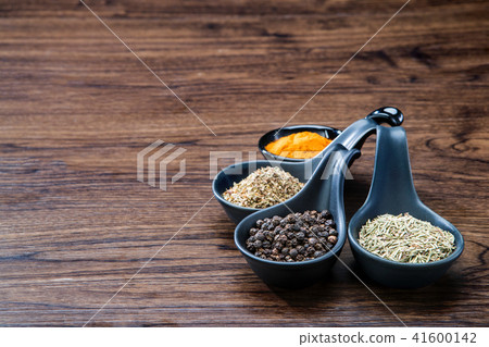 spices and herbs in spoons or bowls on wooden 41600142