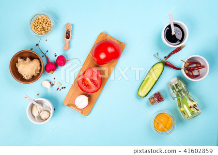 Homemade sauce or salad dressing in bowl with ingredients: fresh herbs, oil, lemon and honey 41602859