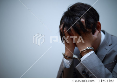 Arrest (failure criminal criminal face none suit business business work handcuffs regrettable copy space male person) 41605168