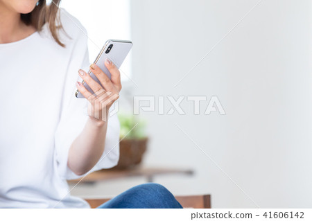 A young lady watching a smartphone 41606142