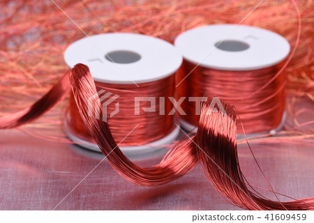 Copper electric coil and wire on metal background 41609459