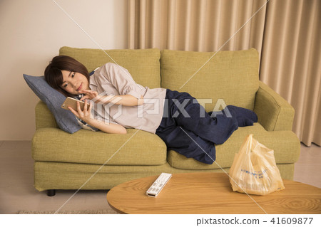A young woman looking at a sleep with lying down 41609877
