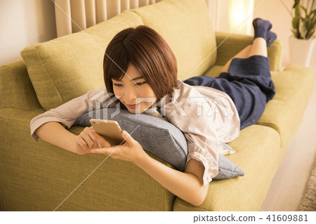A young woman looking at a sleep with lying down A young woman looking at a sleep with lying down 41609881