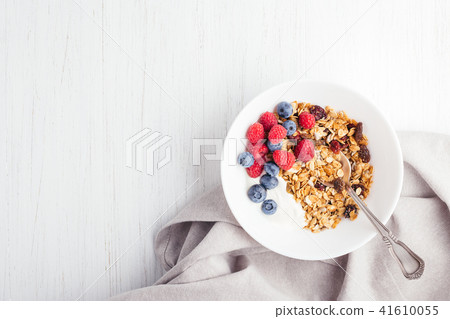 Granola with yogurt in bowl. Granola with yogurt in bowl. 41610055