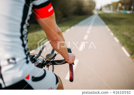 Cyclist in helmet and sportswear rides on bicycle 41610592