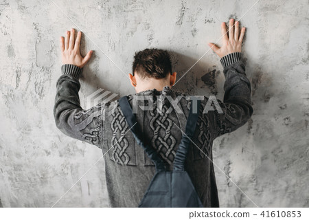 Autistic stands facing the wall, autism syndrome 41610853