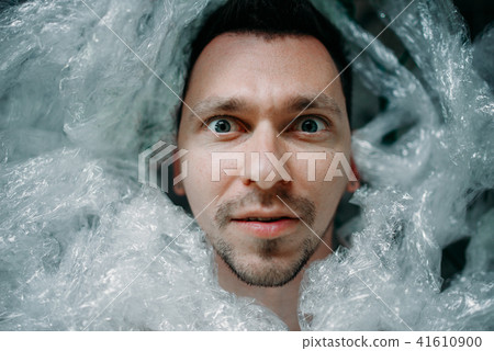 Autist wrapped in packaging film lying in bed Autist wrapped in packaging film lying in bed 41610900