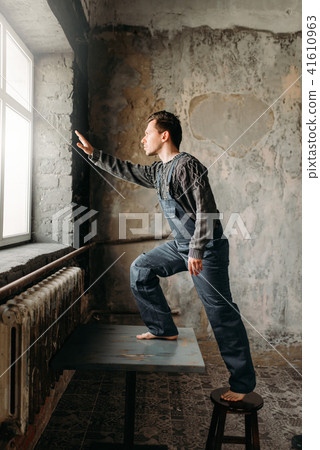 Autistic pulls his hand to window with light Autistic pulls his hand to window with light 41610963