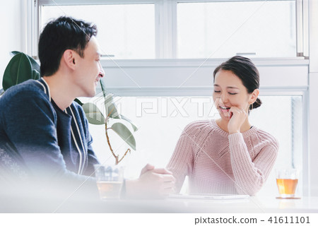 A couple talking with a smile A couple talking with a smile 41611101