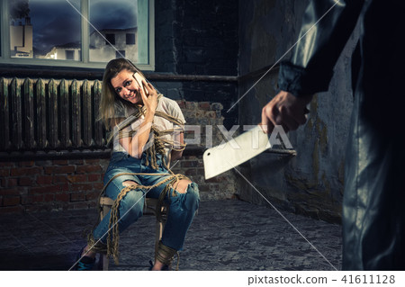 Female victim of the maniac tries to call for help Female victim of the maniac tries to call for help 41611128