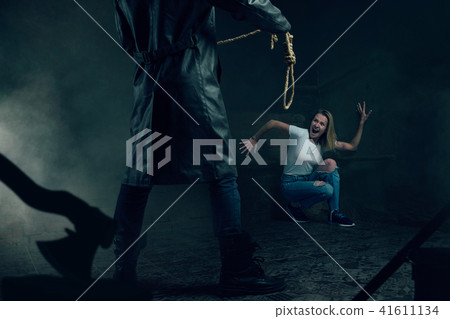 Maniac with rope prepares to strangle his victim Maniac with rope prepares to strangle his victim 41611134