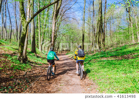 couple riding bicycle in forest in warm day 41613498