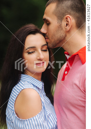 A guy and a girl enjoy each other in a romantic atmosphere 41613627