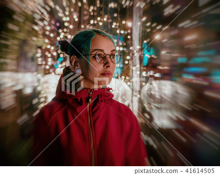 Young beautiful girl with blue dyed unusual hair, transparent glasses, piercing standing at night 41614505