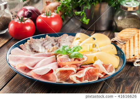 Cold meat platter with ham, bacon and cheese Cold meat platter with ham, bacon and cheese 41616626