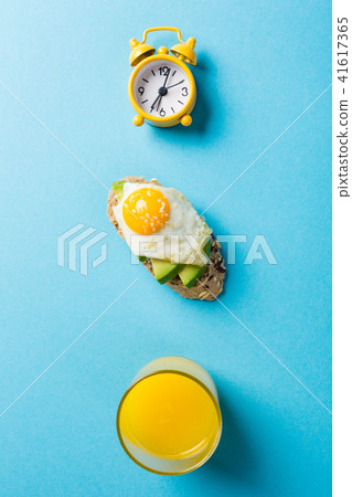 Healthy sandwich with fresh avocado and fried quail eggs 41617365